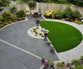 black slate patio laid to semi-circle lawned patch