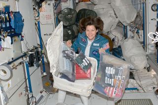 Without a laundry solution on board, 160 lbs. (72.5 kg) of clothing per crew member per year are launched to the space station. Here, Expedition 26 flight engineer Cady Coleman unpacks new clothes on the space station in 2010.