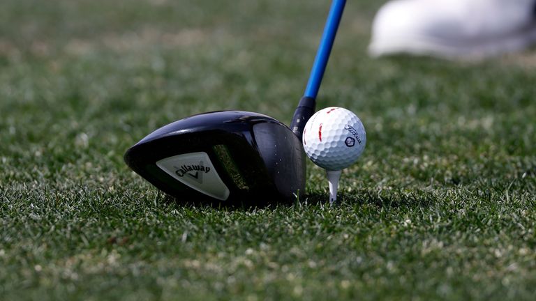 Close up of a driver and a teed up golf ball