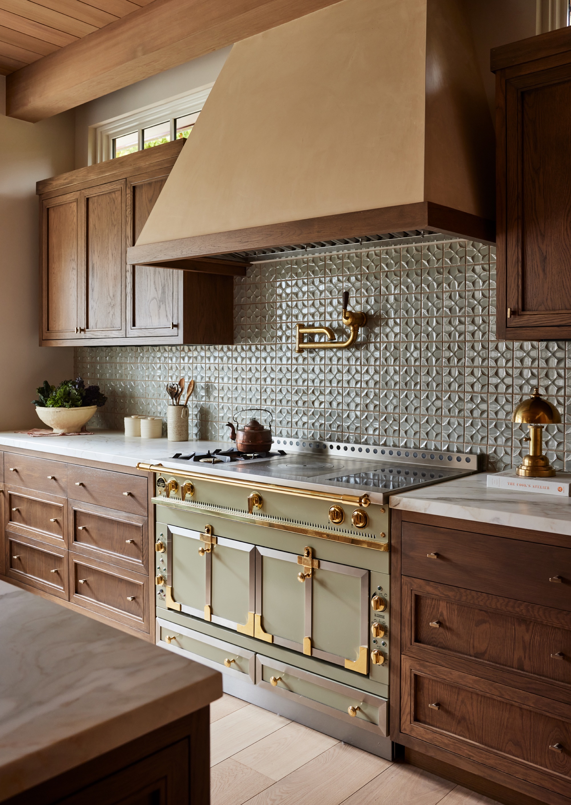 dark wood kitchen with green aga oven and range hood by Kristen Pena
