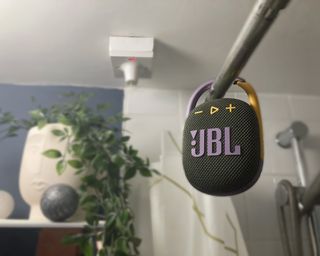 JBL Clip 4 hanging from shower curtain rail in writer's home