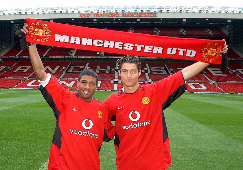 STOKE, ENGLAND - AUGUST 13: Kleberson and Cristiano Ronaldo pose for photographers on the pitch at Old Trafford on August 13, 2003 in Manchester, England. (Photo by John Peters/Manchester United via Getty Images)