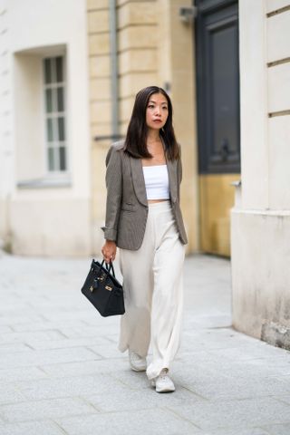 woman wearing tube top, blazer, and trousers