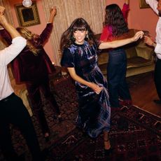 Woman at a house party dancing in a velvet Boden dress