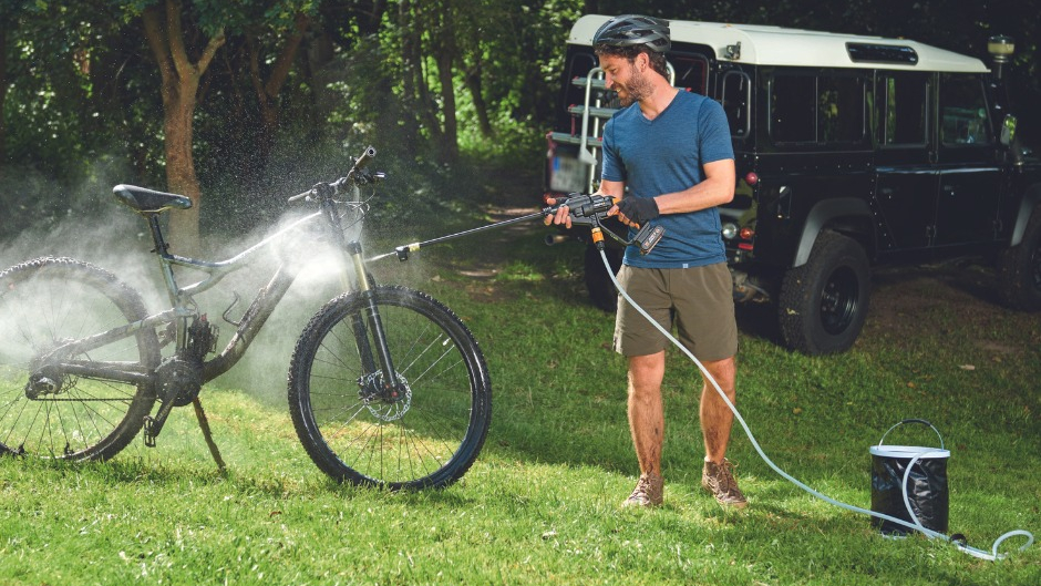 Worx Hydroshot being used to wash a MTB