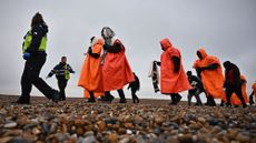 Migrants escorted by British immigration enforcement officers