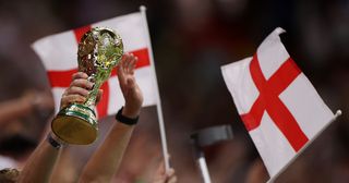 A detailed view of a replica FIFA World Cup trophy held by England fans after the team's victory during the FIFA World Cup Qatar 2022 Round of 16 match between England and Senegal at Al Bayt Stadium on December 04, 2022 in Al Khor, Qatar.