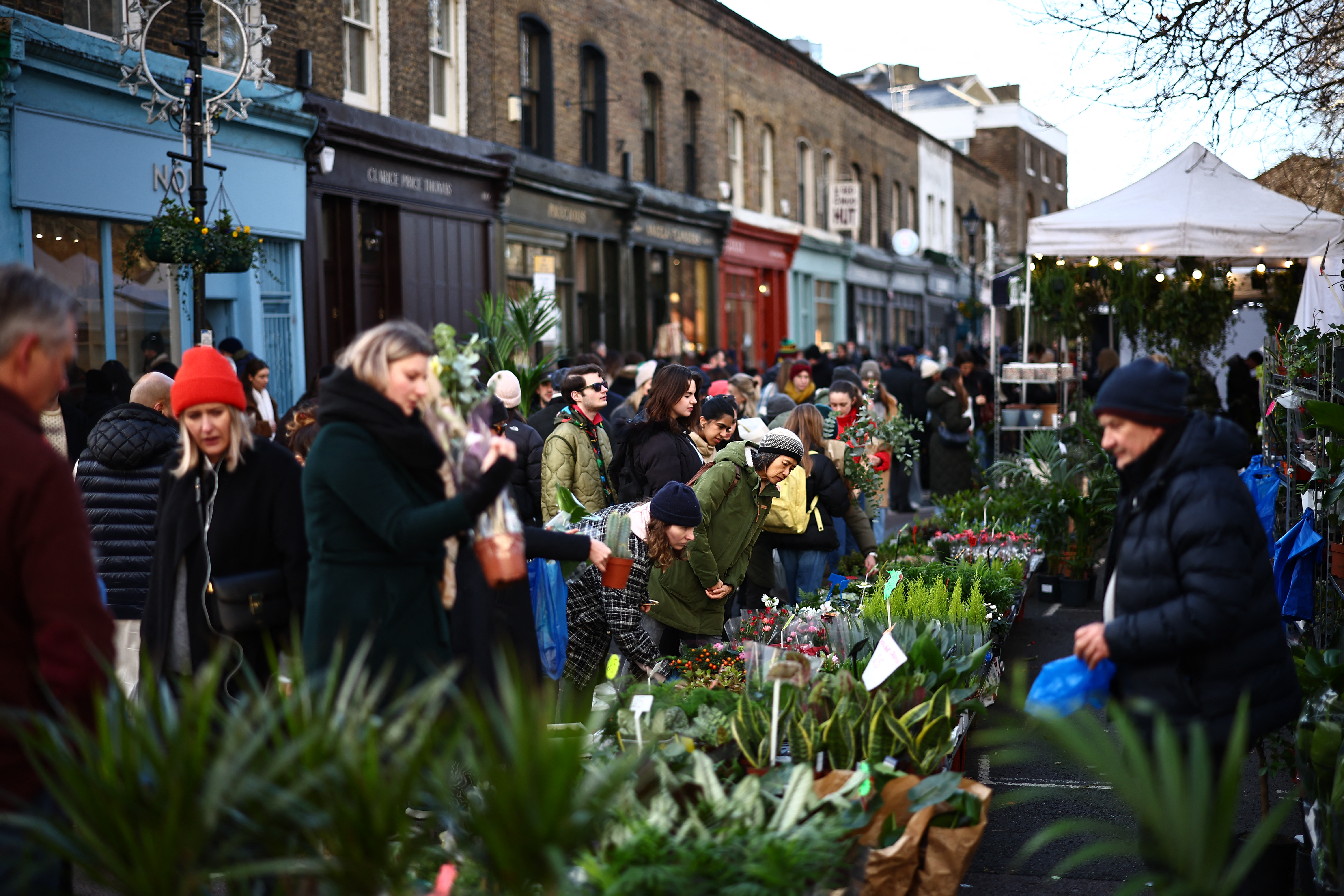 Customers buy flowers on stalls at Columbia Road Flower Market, in east London on January 7
