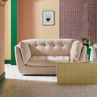 Sofology Cocoon in Textured Chenille Blush with a tiled back wall and a coffee table in yellow tiles