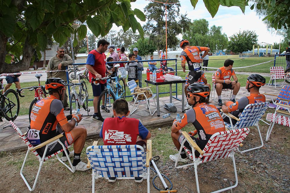 Riders relax before the start of stage 5 in San Juan