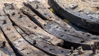 photo shows a close up of some of the planks making up the ship's hull; they're held together with large nails