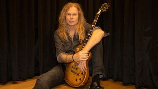 Adrian Vandenberg poses with a Gibson Les Paul