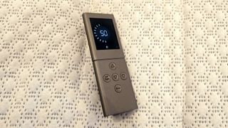 The remote control of the Sleep Number c1 on the surface of the bed