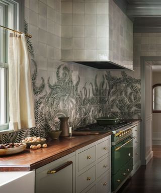 grey green modern farmhouse kitchen with tiled hood and green accents