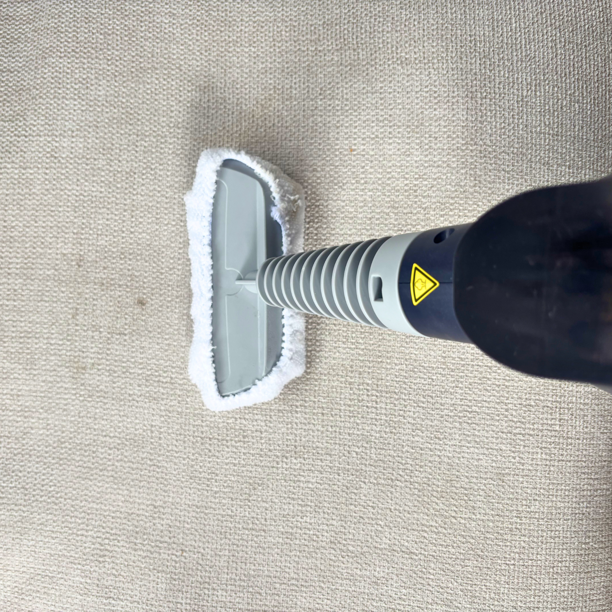Beldray Digital Handheld Steam Cleaner to clean cream sofa