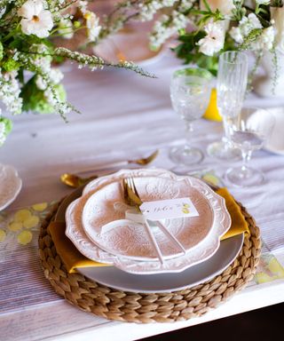 pastel pink tablescape setting with rattan place setting