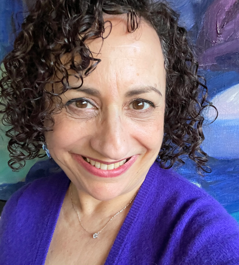 a headshot photo of professional organizer Linda Samuels wearing a purple cardigan