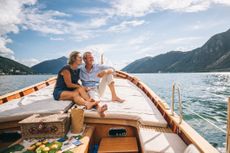 A senior couple enjoys time together on a boat, Lake Lugano, Italy.