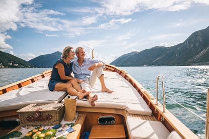 A senior couple enjoys time together on a boat, Lake Lugano, Italy.