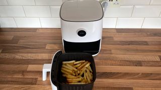 The Mi Smart Air Fryer with french fries that have just been cooked in the frying basket, which has been removed