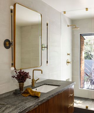 midcentury bathroom with large mirror over the sink