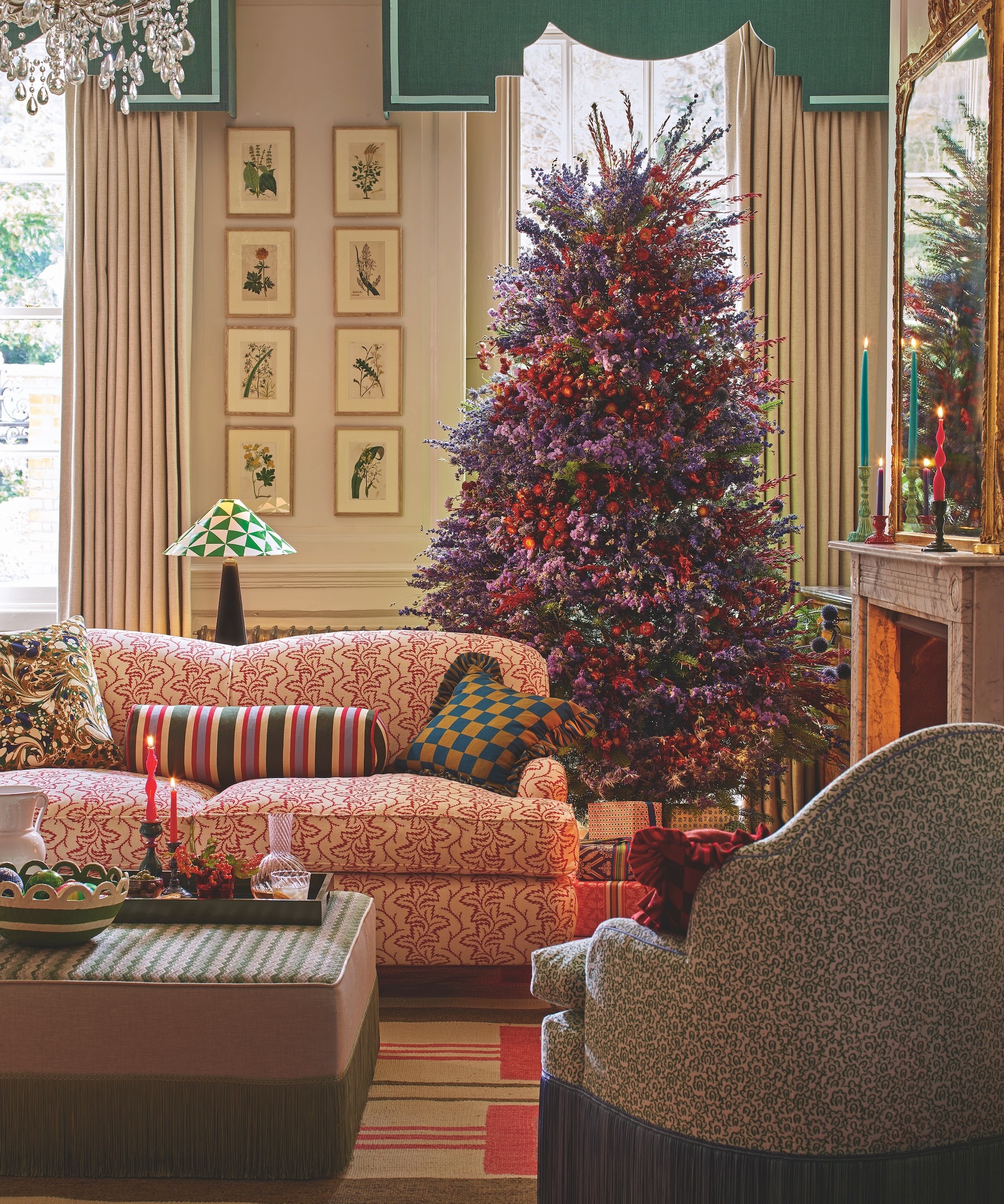 sitting room with patterned red sofa and Christmas tree