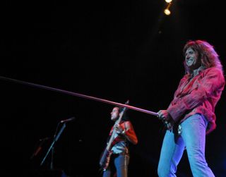 Coverdale gives a familiar salute on the Rock Never Stops tour, 2003
