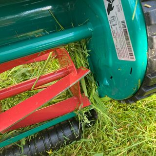 a hand push lawn mower blades clogges with grass
