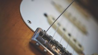 Electric guitar strings being fitted to a Stratocaster