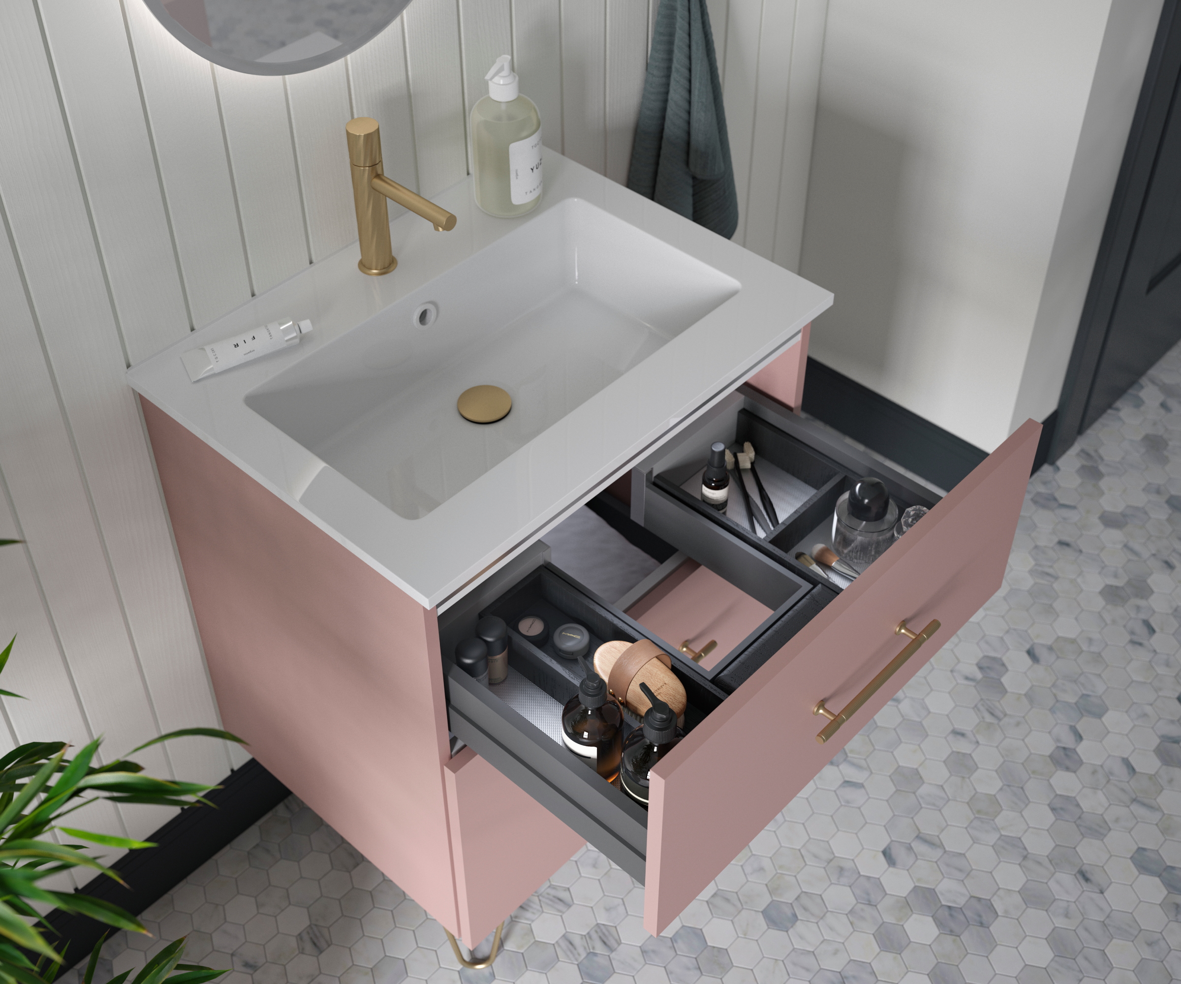 pink vanity unit with white sink, one drawer open to show contents