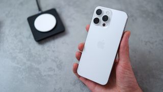 Photo of a white Apple iPhone 15 Pro Max being held in someone's hand