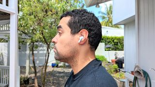 Tom's Guide reviewer assessing sound quality on LG Tone Free T90 earbuds