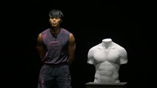 amotti stands next to his torso bust, in the 'physical 100' season 2 finale