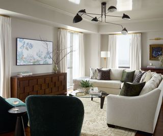 living room with white sectional sofa and teal armchairs