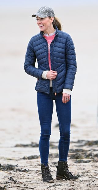 Kate Middleton in a pair skinny jeans, boots and a waterproof jacket