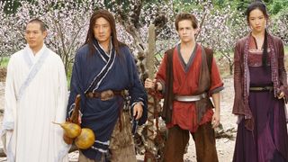 Jet Li and Jackie Chan stand in a forest in The Forbidden Kingdom