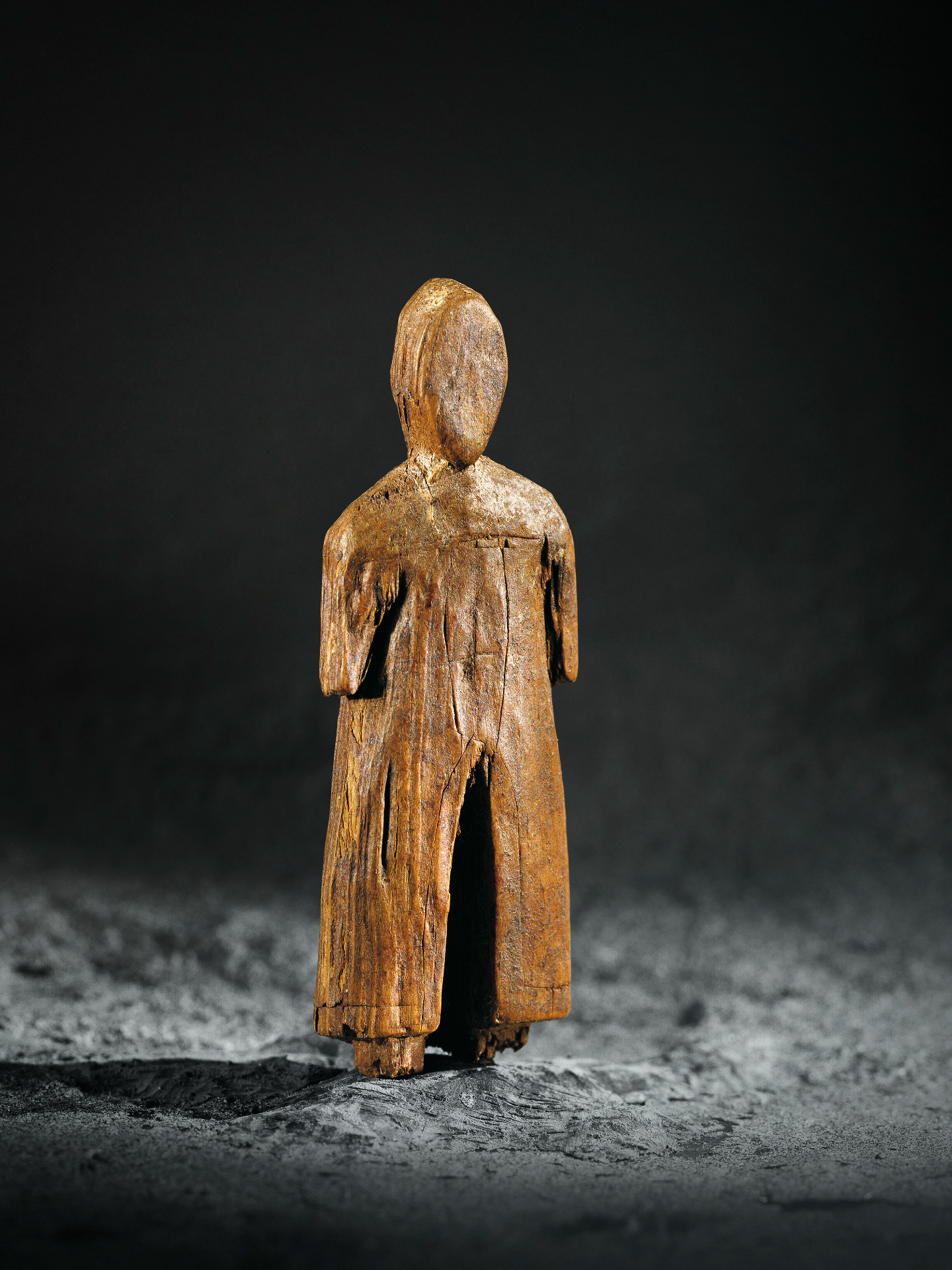 a wooden carving of a person