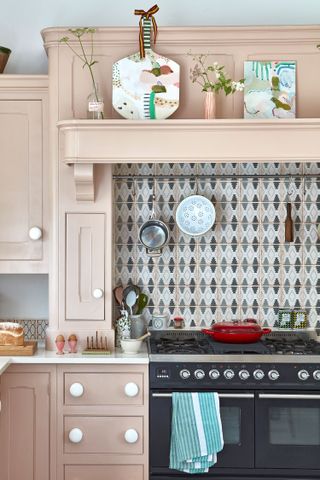 pink kitchen cabinets with geometric pink and grey tiles
