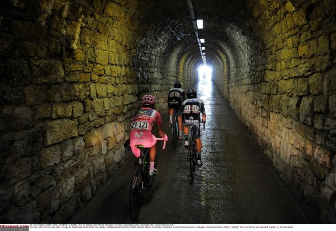 The maglia rosa group heads through the tunnel on the Monte Zoncolan, getting a brief respite from the crowds