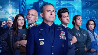 The cast of Space Force (L to R) Don Lake as Brad Gregory, Diana Silvers as Erin Naird, John Malkovich as Dr. Adrian Mallory, Steve Carell as General Mark Naird, Ben Schwartz as F. Tony Scarapiducci, Tawny Newsome as Angela Ali and Jimmy O. Yang as Dr. Chan Kaifang, standing in their suits.