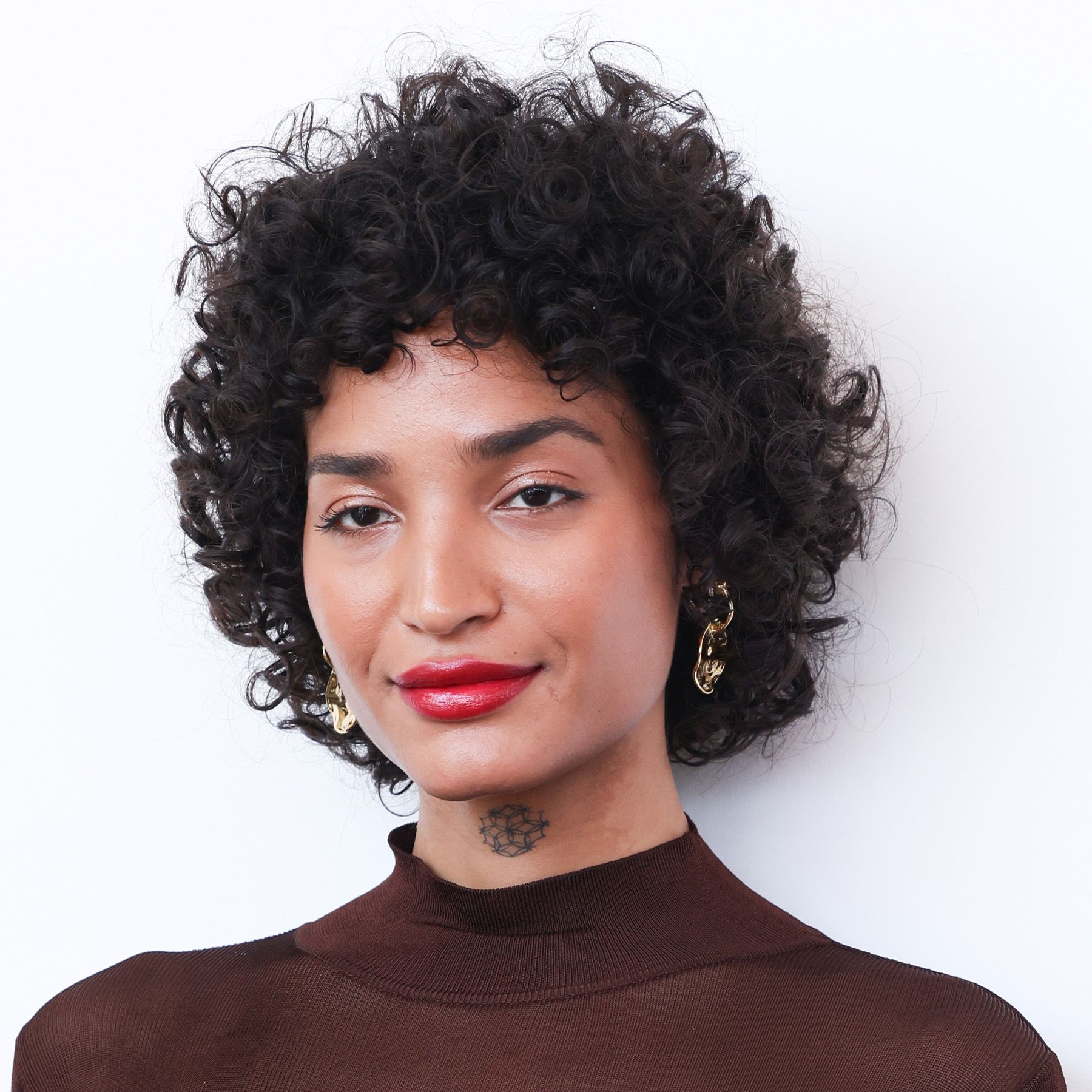 Indya Moore attends the "Father Mother Sister Brother" photocall during the 82nd Venice International Film Festival with a wolf cut