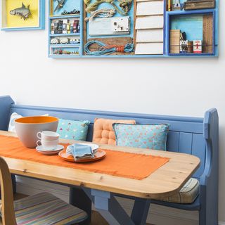 dining room with blue bench and wooden table with chairs