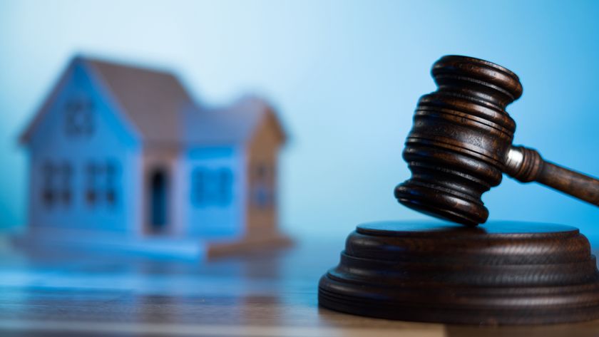 Gavel with model house in background