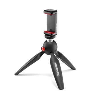 A black Manfrotto PIXI tripod with Universal Smartphone Clamp