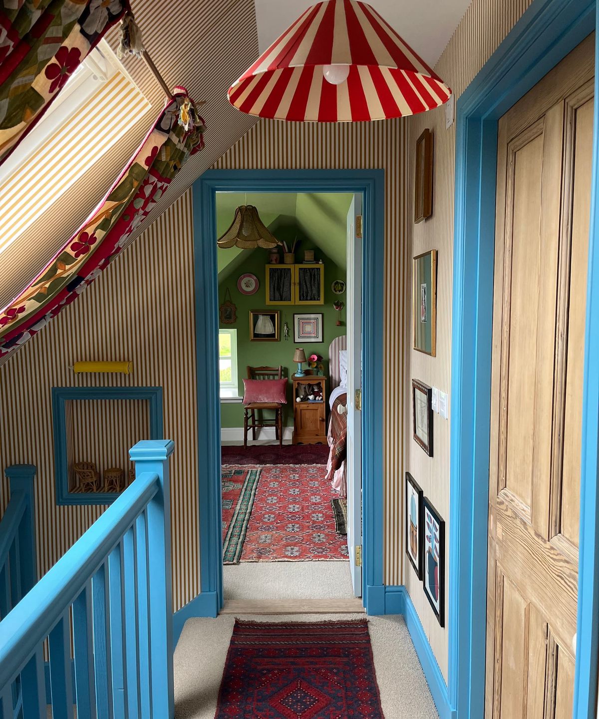 An upstairs hallway with blue bannisters