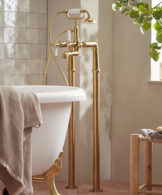 brass floor-mounted tap and shower
