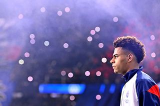 Desire Doue of Paris Saint-Germain walks on the pitch before the Ligue 1 match between Paris Saint-Germain and Olympique de Marseille at Parc Des Princes on March 16, 2025 in Paris, France.