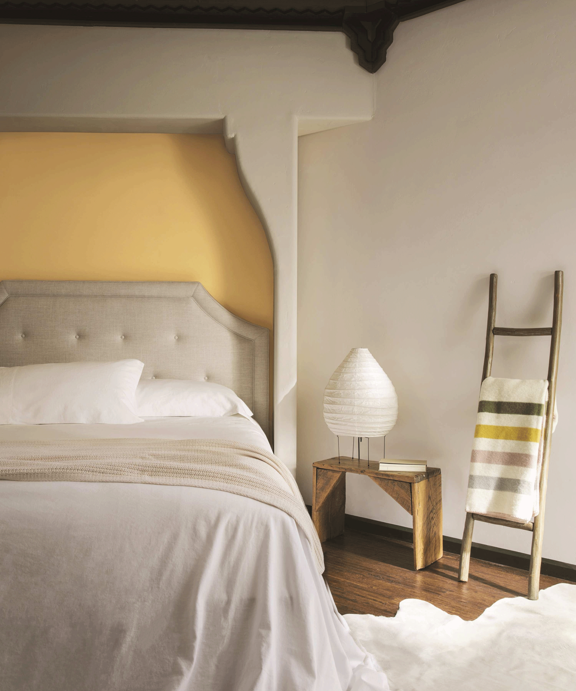 Beige bedroom with yellow statement wall