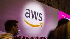 Amazon Web Services (AWS) logo projected onto a white wall at Web Summit Lisbon.