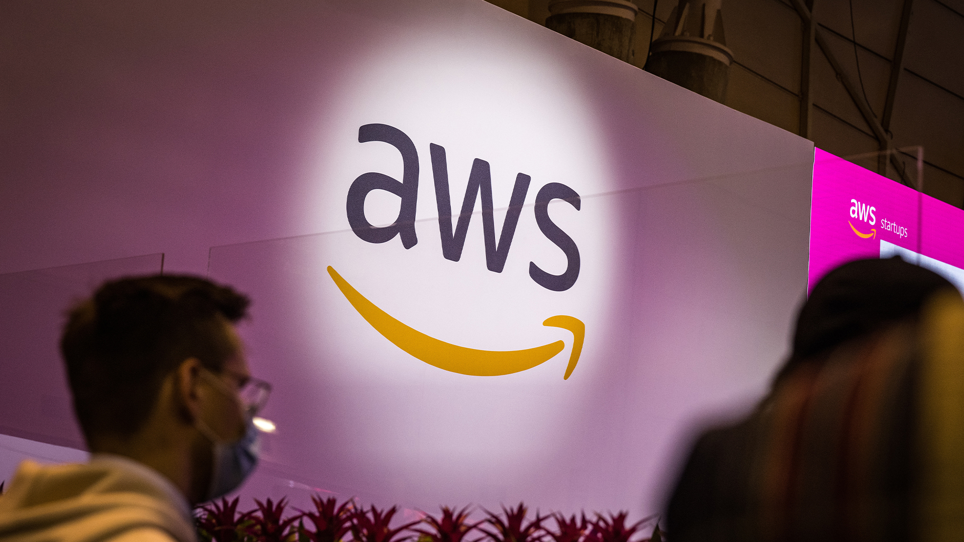 Amazon Web Services (AWS) logo projected onto a white wall at Web Summit Lisbon.